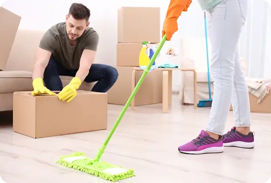 A man and woman are tidying up a room